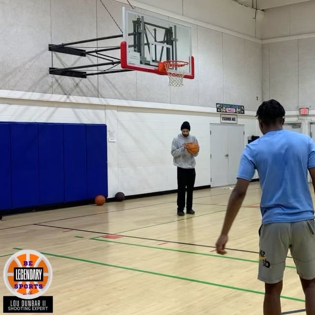 Lou Dunbar II coaching a player through a pull-up jumper
